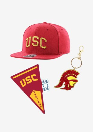 man and woman posing with USC hats, scarves, gloves, and other accessories